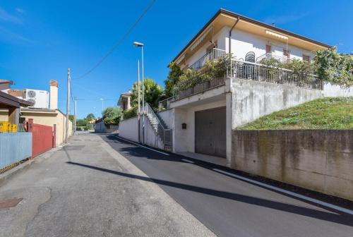 an empty street with a house with a garage at La Maison de Mely with garden in Sandra