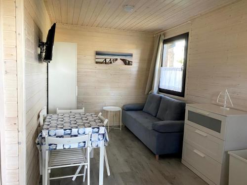 a living room with a couch and a table at A Morze Ustka in Ustka