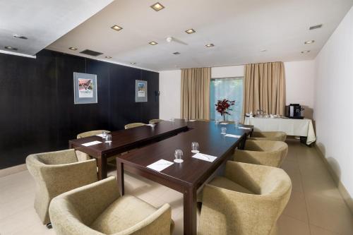 a meeting room with a long table and chairs at Hotel CH Bucharest in Bucharest