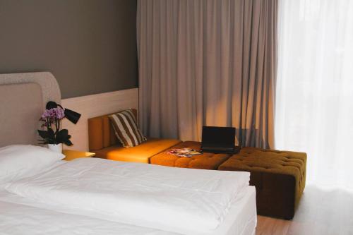 a hotel room with two beds and a laptop on a table at SCOTTY & PAUL Hotel Deggendorf in Deggendorf