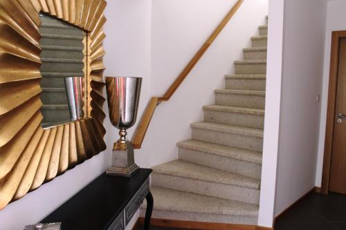 a stairway with a glass trophy on a dresser at Casal da Porta - Quinta da Porta in Mirandela