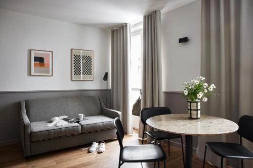 a living room with a couch and a table at Base Lausanne in Lausanne