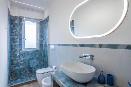 a bathroom with a sink and a toilet and a mirror at A Casa di Ale in Cinisello Balsamo