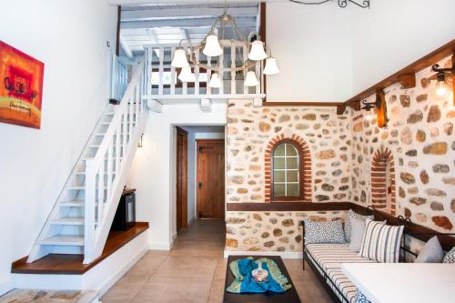 a living room with a staircase and a couch at Acrotel Athena Residence in Elia