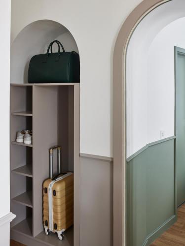 an archway with a suitcase sitting on a shelf at Base Lausanne in Lausanne