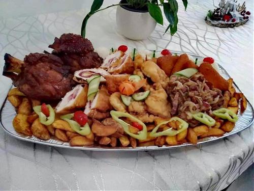 a plate of food with meat and french fries at Jolán Pension & Restaurant in Číčov