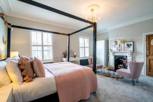 a bedroom with a large bed and a fireplace at 46 Nunnery Lane in York