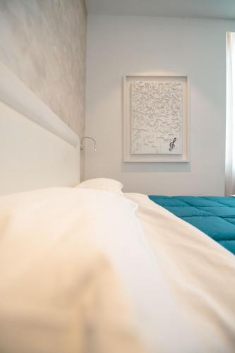 a bedroom with a white bed and a window at Hotel Bruman Salerno in Salerno