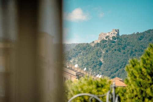 a castle on top of a mountain with trees at Hotel Bruman Salerno in Salerno