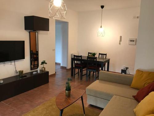 a living room with a couch and a dining room at We Love Home Rome in Rome