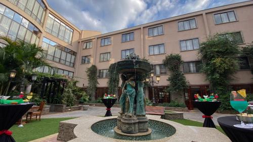 a fountain in the courtyard of a building at Sarova Woodlands Hotel and Spa in Nakuru