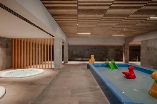 a room with a swimming pool with toy figures in it at VacationClub – Poleska 4C Apartament 7 in Kołobrzeg