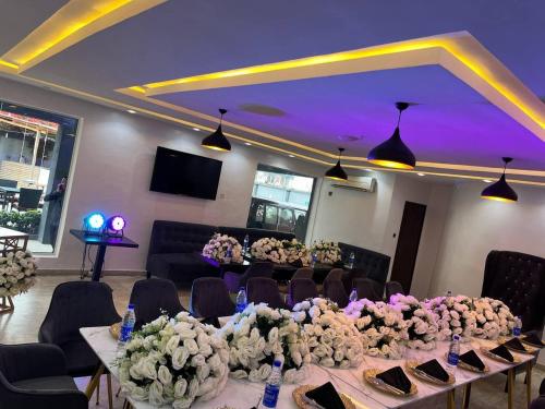 a room with a long table with flowers on it at HIS Dulce Apartments in Lagos