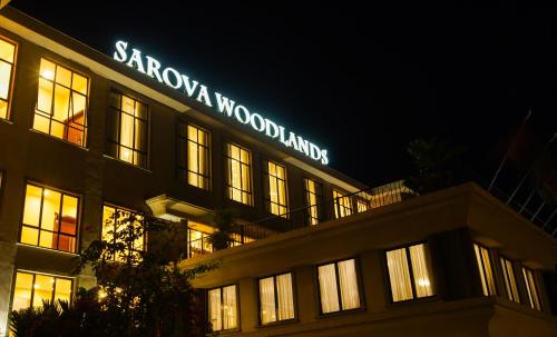 a building with a sign on top of it at night at Sarova Woodlands Hotel and Spa in Nakuru