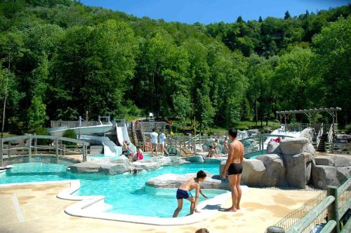 a group of people in a pool at a water park at SDCPM Maison de Maitre in Conliège