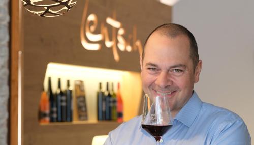 a man holding a glass of red wine at Winzerhof Lentsch in Jois