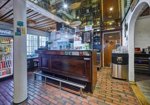 a bar in a restaurant with a wooden counter at Hotelli-Ravintola Gasthaus Lohja in Lohja