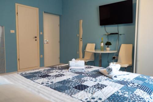 a blue bedroom with a bed with a teddy bear on it at Apartments & Rooms Andrea 2 in Zadar