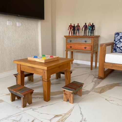 a living room with a coffee table and a dresser at Pousada Alpes Azul in Campos do Jordão