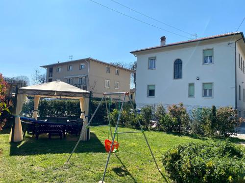 a house with a lawn chair in front of it at Villa Catelli B&B in Lucca