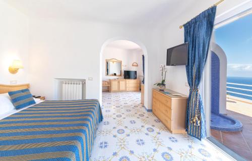 a hotel room with a bed and a television at Hotel Grazia alla Scannella in Ischia