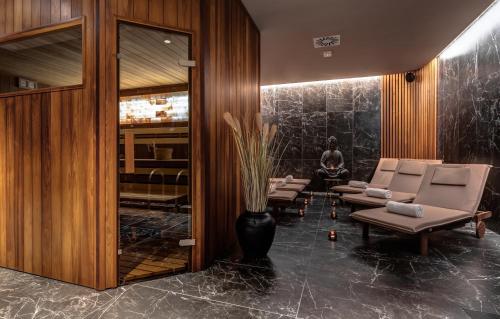 a lobby with chairs and a vase with a plant at Hotel Central Park in Poděbrady