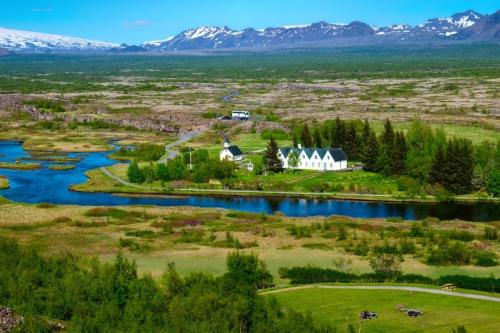 an aerial view of a house and a river at EYVÍK Cottages - Private HOT TUB! in Selfoss