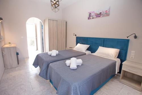 a bedroom with two beds with towels on them at Dionisos Apts Gouvia by Estia in Corfu