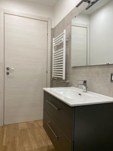 a bathroom with a sink and a mirror and a shower at Casa Giulia in Catania