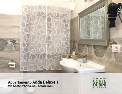 a bathroom with a sink and a mirror at Conte Durini Apartments & Rooms in Arcore