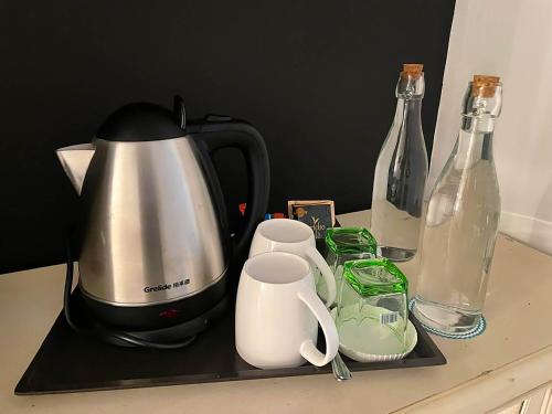 a coffee maker and bottles on a counter at Bamboo Boutique Hotel in Lilongwe