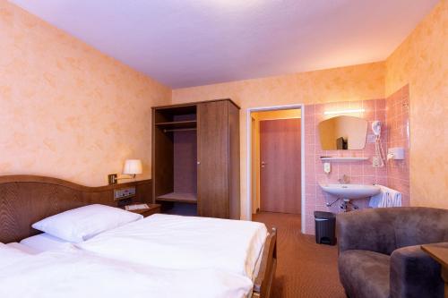 a hotel room with a bed and a sink at Hotel-Restaurant Weinhaus Grebel in Koblenz