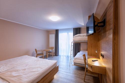 a hotel room with a bed and a desk and a bedroom at Hotel-Restaurant Weinhaus Grebel in Koblenz
