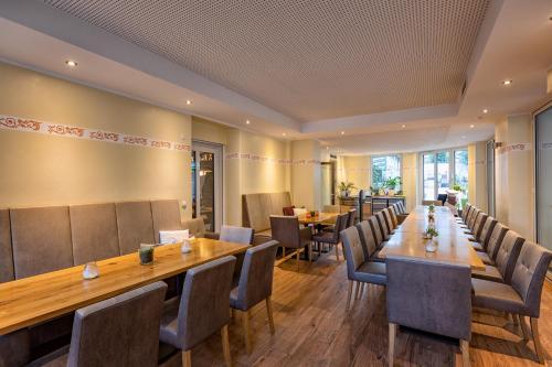 a dining room with a long table and chairs at Hotel-Restaurant Weinhaus Grebel in Koblenz