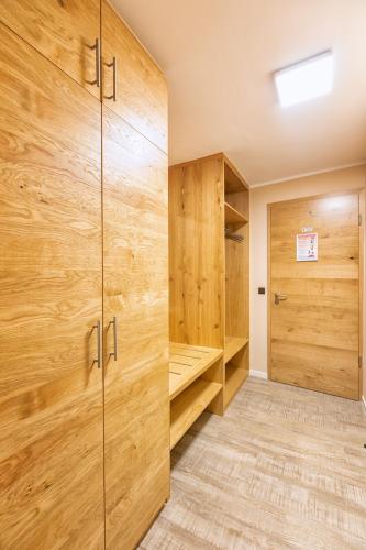 a walk in closet with wooden walls and wooden cabinets at Hotel-Restaurant Weinhaus Grebel in Koblenz