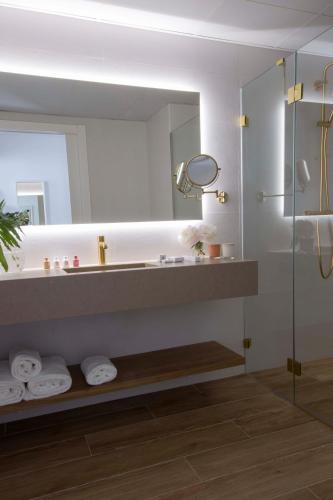 a bathroom with a shower and a sink and a mirror at May Altafulla Beach Boutique Hotel in Altafulla
