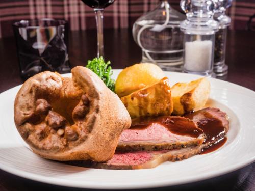 a plate of food with a sandwich and bread at Stirk House Hotel in Clitheroe