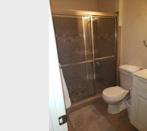 a bathroom with a toilet and a glass shower at Why Not enjoy while away! in Harrisonburg