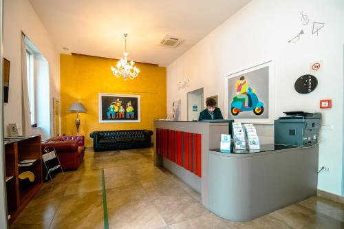 a restaurant with a counter in the middle of a room at Hotel Bruman Salerno in Salerno
