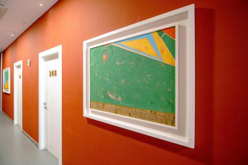 a painting hanging on a wall in a hallway at Hotel Bruman Salerno in Salerno