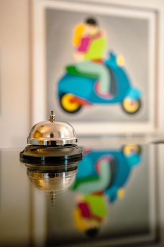 a close up of a bell on top of a mirror at Hotel Bruman Salerno in Salerno