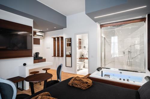 a living room with a bath tub and a room with a table at Residenze Chamur- Grattacielo in Palermo
