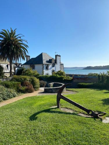 a statue in the grass in front of a house at White and Sea Lodge in Locquirec