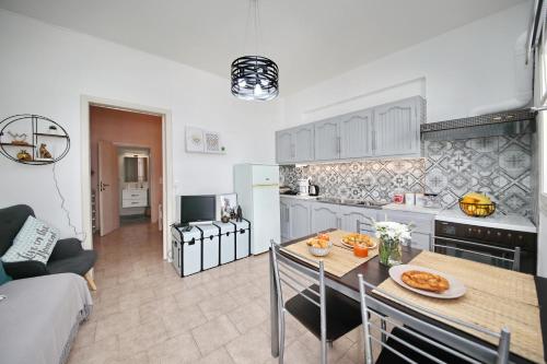 a kitchen and living room with a table and chairs at Vanilla guesthouse in Skopelos Town