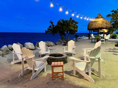a group of chairs and a fire pit on the beach at Villa Valbuena Azul Escape 2 Kings Key Largo Pickleball Tennis Pool Lagoon in Key Largo