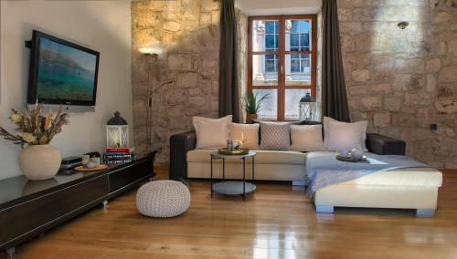 a living room with a couch and a table at Loft in Ismaelli Palace Korcula in Korčula
