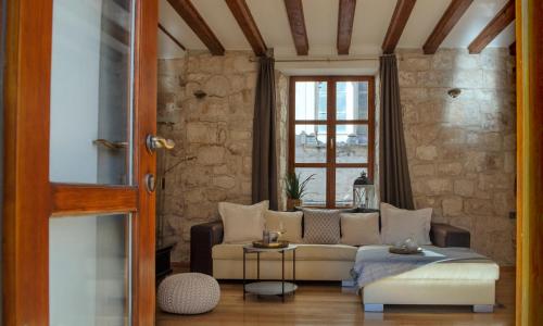 a living room with a couch and a window at Loft in Ismaelli Palace Korcula in Korčula