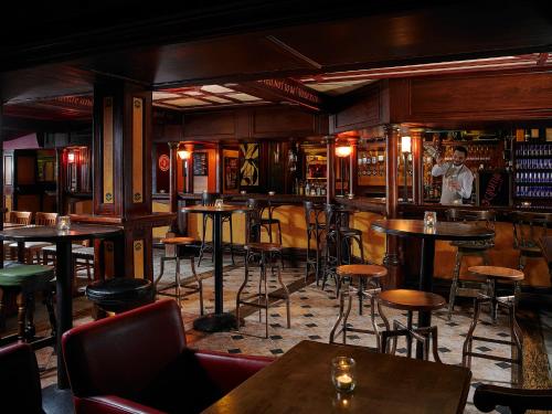 a bar with tables and stools in a room at Killarney Towers Hotel & Leisure Centre in Killarney