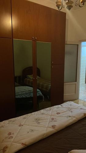 a bedroom with a bed and a large mirror at da Lilia in Salute&Bellezza in Monfalcone