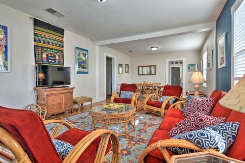 a living room with red couches and a tv at Eureka Cottage Near Sequoia Park and Old Town! in Eureka